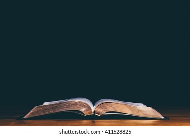 Open bible and black background - Shutterstock ID 411628825