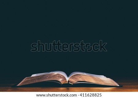 Open bible and black background