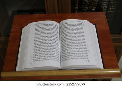 An open Bible book on a stand and a bookcase in the background
05 05 2022 Afula Israel