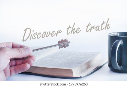 Open Bible Book On The Table And Cup. Inscription Discover The Truth.