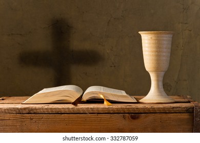 open bible with chalice of wine in the church