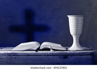 open bible with chalice of wine in the church,selective focus