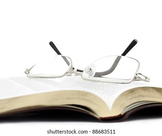 Open Bible With Glasses Closeup On White