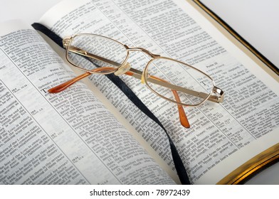 Open Bible With Glasses  Isolated On White Background