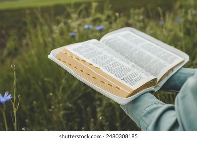 Open bible in hands close-up, concept of calmness and morning solitude. - Powered by Shutterstock