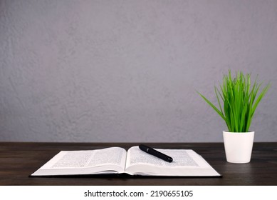 Open Bible. Holy Bible On The Table. Pen And Notepad. Green Vase.