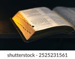 Open Bible on a black background. Religion concept.