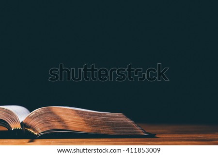 Open Bible on black background