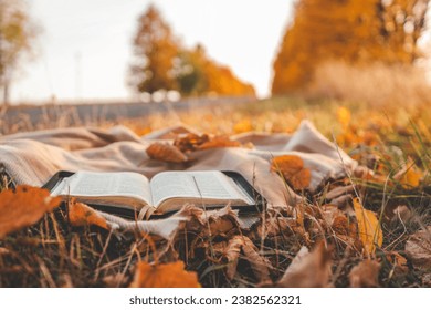 Open Bible on a blanket, autumn. - Powered by Shutterstock