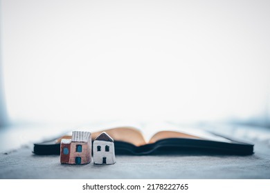 Open Bible On A Light Background With A Miniature Church. Online Service Concept