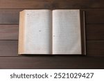 Open Bible on wooden table, top view