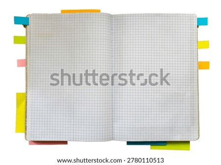 Open blank graph paper notebook with colorful sticky tabs around the pages, suitable for planning, study, organization, and stationery design concepts.