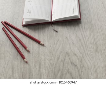 Open blank notepad and pencils on wooden table. Back to school, Top view, Copy space.