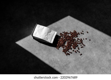 Open blank packaging doy pack coffee mockup, on concrete background, with coffee beans, sharp natural sunlit shadows. Packaging mockup template with empty space to display your branding design.shalf