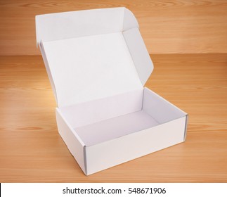 Open Blank White Box Mock Up On Wood Background.