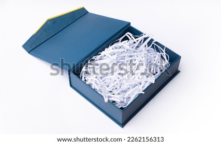 Open blue navy box with shredded paper above top view isolated