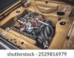 Open bonnet of a classic car displaying fully restored engine compartment.