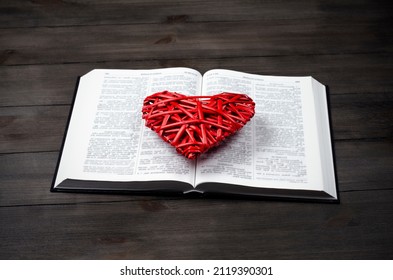 Open book, Bible. On the table. Red heart. The concept of love for God and Scripture. - Shutterstock ID 2119390301