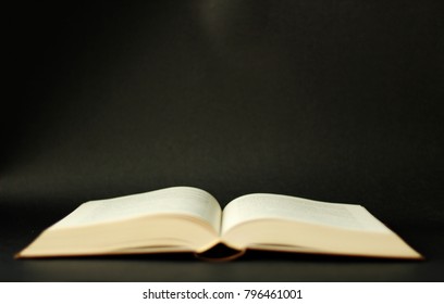 Open book, black background - Shutterstock ID 796461001