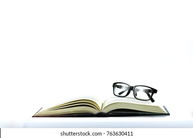 The Open Book And The Black Vintage Eye Glasses Isolated With The White Background, In Concept Of Education And Business