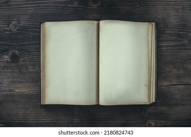 Open Book With Blank Pages On A Wooden Table. Mockup Of An Old Book On A Table Top View.