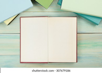 Open book with blank pages on textured wood background. Copy space