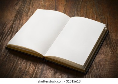 An Open Book With Blank Pages On Wood Table
