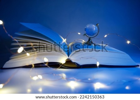 open book blue lights glass globe