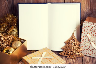 Open Book With Christmas Decoration On Wooden Background