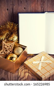 Open Book With Christmas Decoration On Wooden Background