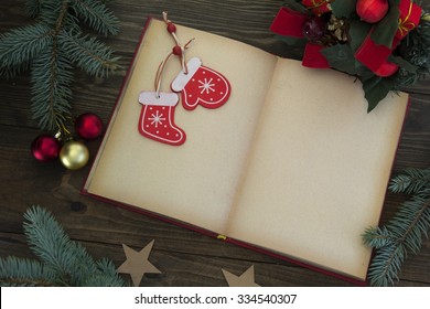 Open Book , Elechnye Decorations And Christmas Sock On The Table