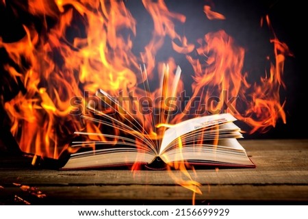 Open book with flames fire. Concept of freedom information, 451 fahrenheit, old literature.