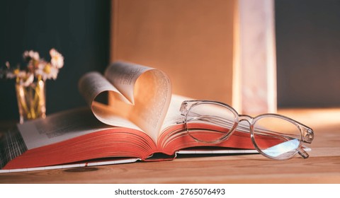 Open book forms heart shape with pages in soft light showcasing reading, love for literature, and the joy of gaining knowledge at a cozy reading spot