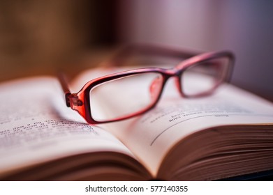 open book with glasses