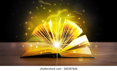 Open Book With Golden Glow Flying Paper Pages On Wooden Deck