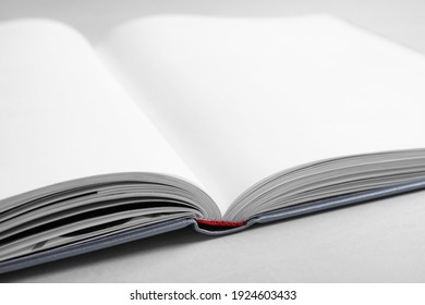 Open Book With Hard Cover On Light Grey Table, Closeup