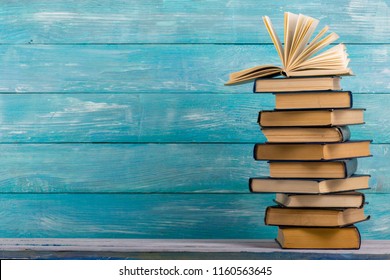 Open book, hardback books on wooden table. Back to school. Copy space - Shutterstock ID 1160563645