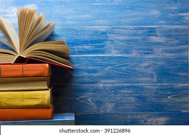 Open book, hardback books on wooden table. Back to school. Copy space for text