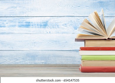 Open book, hardback books on wooden table. Back to school. Copy space for text. Education background.