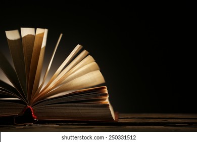 Open Book With Light Over Dark Background