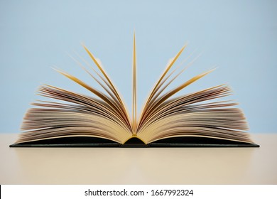 Open Book On Blue Background