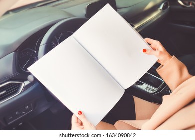 Open book on the car steering wheel in hand mockup.