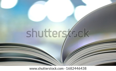 open book on colorful blurred background