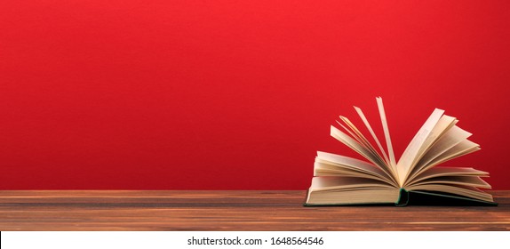 Open book  on red background. text place  - Image  - Powered by Shutterstock