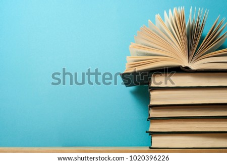 Open book on stack of books on wooden table. Education background. Back to school. Free copy space.