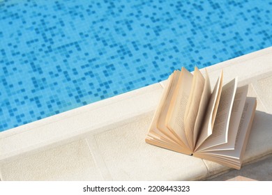 Open Book On Swimming Pool Edge During Sunny Day, Above View. Space For Text