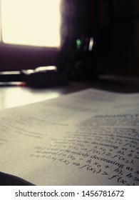open book on a table in front of a window