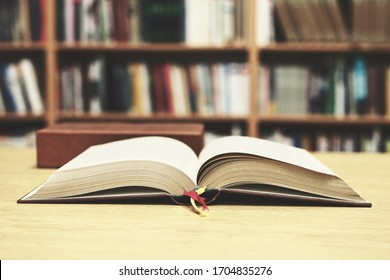 Open book on the table in library - Shutterstock ID 1704835276
