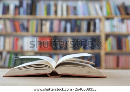 Open book on the table, 
stack of books,stack of books on white blurred background, education, reading, 
High quality photos of books, school, library, William Shakespeare, literature, AI