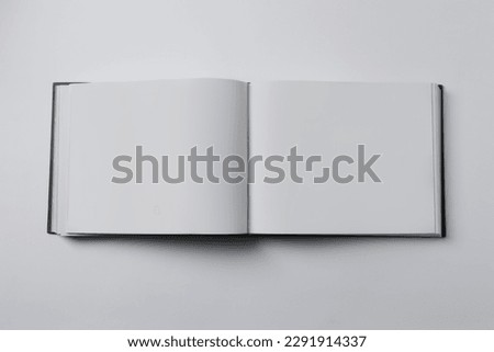 Open book on white background, top view